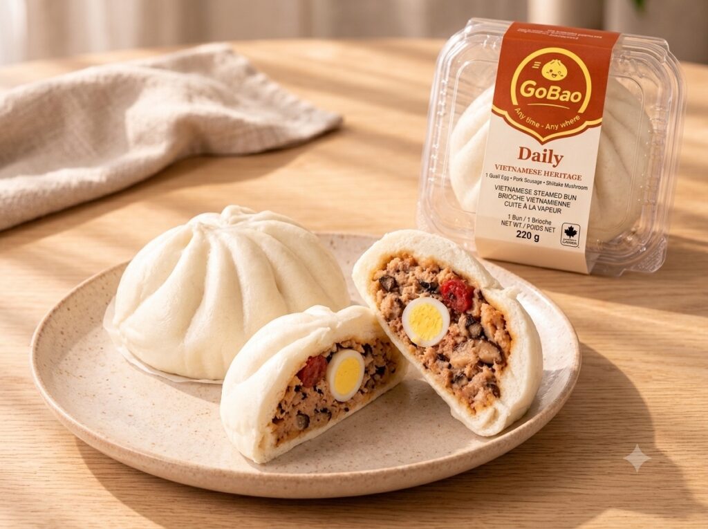 Go Bao Daily bao, whole and cut open on a plate, beside its packaging.