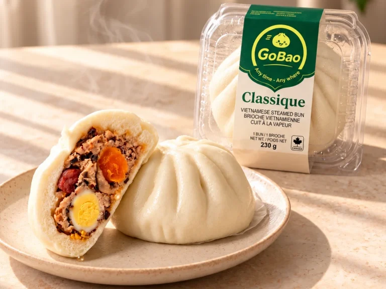 GoBao Classique Vietnamese steamed bun (bánh bao) with salted egg yolk, quail egg and pork sausage, shown cut open beside its package