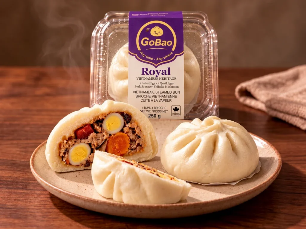 GoBao Royal Vietnamese steamed bun (bánh bao) with salted egg, quail eggs, pork sausage and shiitake, shown cut open beside its package