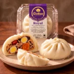 GoBao Royal Vietnamese steamed bun (bánh bao) with salted egg, quail eggs, pork sausage and shiitake, shown cut open beside its package
