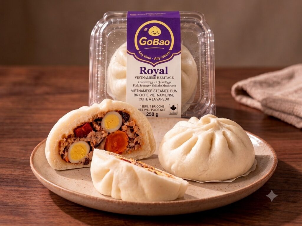 Go Bao Royal bao, whole and cut open on a plate, beside its packaging.
